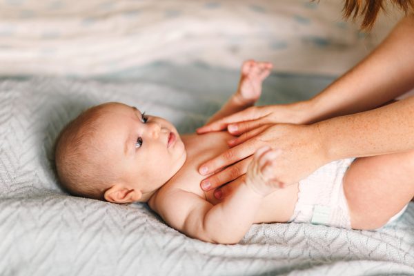 Mom,Hugs,With,Her,Newborn,Baby,In,Bed.,Four,Month